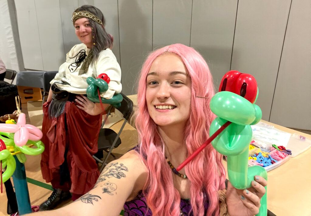 Costume Characters for Hire NH: a pirate and mermaid twisting balloons for kids