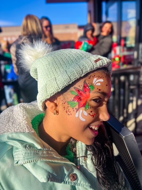 A poinsettia flower face painting