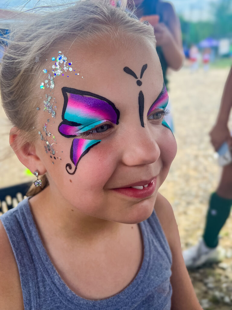 Girl with butterfly sparkle face painting