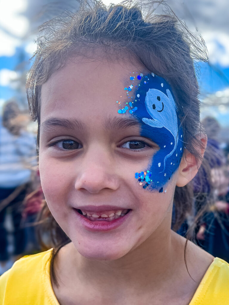 A girl with a cute ghost face painting